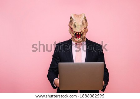 Euphoric man with lizard head with laptop