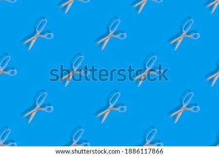 Seamless patterns. Seamless pattern from hairdressing scissors. Scissors on a blue background.