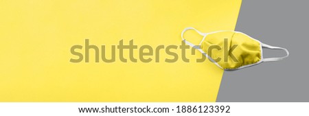 Medical horizontal banner, header with copy space. Protective reusable mask. Ultimate Gray and Illuminating yellow colors of the year 2021. Fashion trendy epidemic concept. Healthcare virus protect.