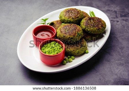 Hara bhara Kabab or Kebab is Indian vegetarian snack recipe served with green mint chutney over moody background. selective focus Royalty-Free Stock Photo #1886136508