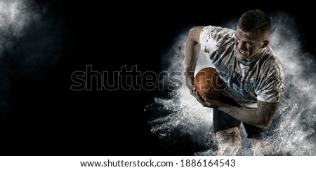 Man rugby player holds ball. Sports banner. Horizontal copy space background Royalty-Free Stock Photo #1886164543