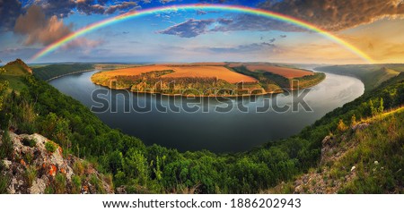 colorful rainbow over river canyon