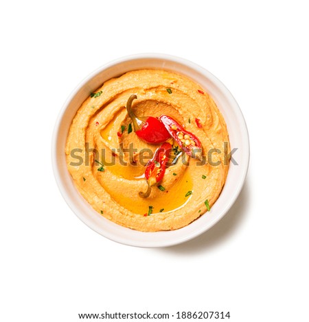 Roasted red pepper hummus isolated on white background.