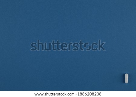 Medical pill on blue background