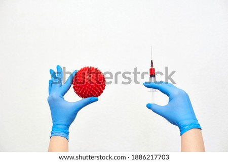 coronavirus vaccine, vaccination of the population against the disease, fighting the epidemic, hands in medical gloves holding a syringe with medicine