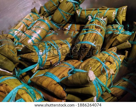 Buras is a traditional food from Makassar. A process to cook rice wrapped with banana leaves above the stove. Royalty-Free Stock Photo #1886264074