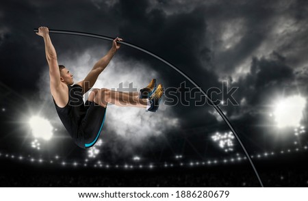 Professional pole vaulter training at the stadium in the evening. Sports banner. Horizontal copy space background Royalty-Free Stock Photo #1886280679