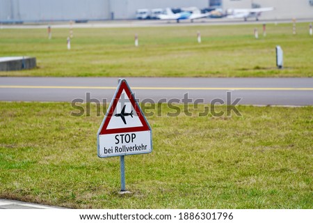 Traffic sign at airfield runaway at Swiss Airport Zürich Kloten with text stop in case of taxiing traffic on a winter day. Photo taken January 3rd, 2021, Zurich, Switzerland.