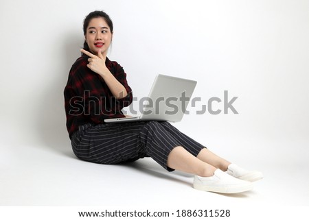 The young Asian woman with casual clothes on the white background.