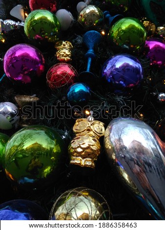 multicoloured balls and golden owl on the Christmas tree