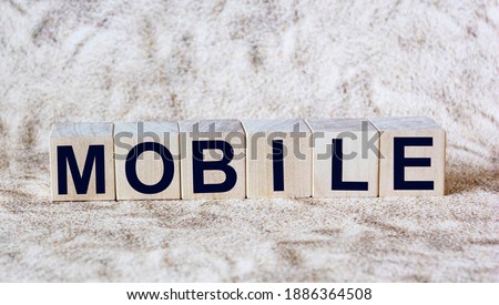 word Mobile written on wooden cubes and light background