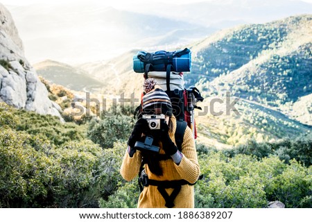 Girl hiker with backpack take a picture. Travel lifestyle concept.