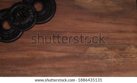 dumbbell discs on wooden background