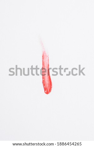 red lipstick sample on white background