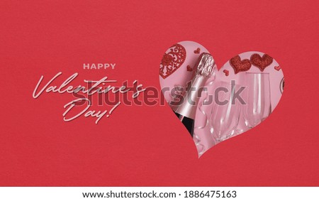 Happy valentine's day text and heart shape cut out in paper with champagne and glasses - holiday party 