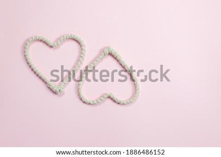 Hearts made of rope on a pink background. Valentine's Day background. Valentine's Day concept. Flat lounger, top view, copy space.