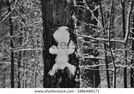 A man made of snow on a tree in a fairy forest.  Traveling in Russia