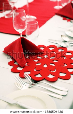 Beautiful red and white place settings on a table for Christmas dinner