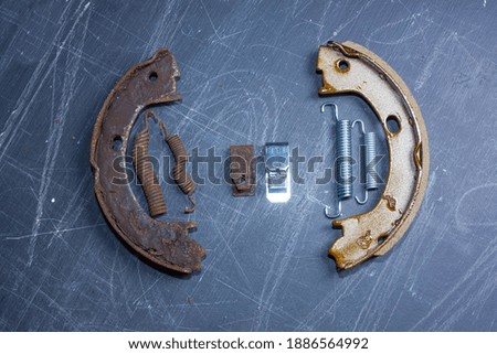 hand parking brake pad replacement concept, old rusty auto parts are new.