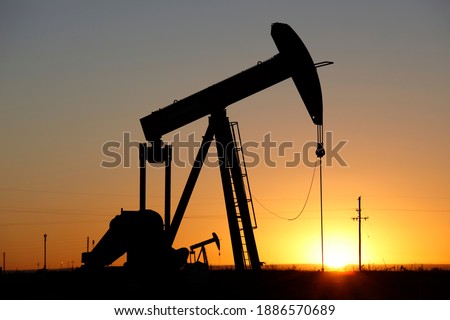 Pumpjacks, the sunset of New Mexico oil field, shot near Carlsbad. Royalty-Free Stock Photo #1886570689