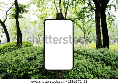 Blank banner with wooden frame on unfocused park stock photo