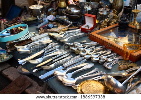 Antiques on flea market or festival, vintage silver cultery - spoons, knifes, forks and other vintage things. Collectibles memorabilia and garage sale concept Royalty-Free Stock Photo #1886597338