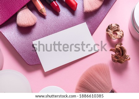 Paper business card flat lay mock up on pink cosmetic table