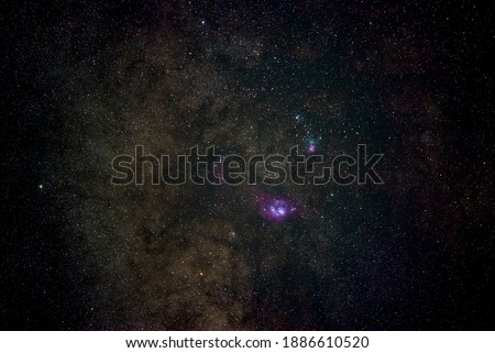 Lagoon and trifid nebula in milky way with stars and space dust in Long exposure photograph, with noise and high ISO