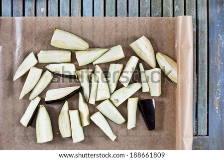 Chopped aubergine for baking on oven proof paper Royalty-Free Stock Photo #188661809