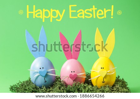 Easter eggs and cute bunny on green background. Festive decoration. Happy Easter. Minimal concept. 