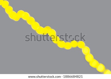 Abstract yellow neon blurred diagonal line on gray background. Demonstrating trendy colors 2021 - Gray and Yellow.