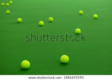 Tennis ball on a greenbackground