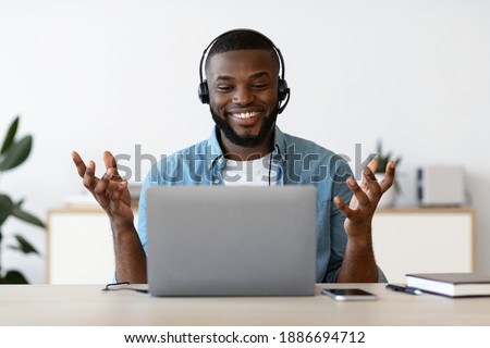 Video Call. Cheerful African American Man In Headset Having Online Meeting With Laptop At Home, Smiling Black Freelancer Guy Making Web Conference On Computer, Enjoying Online Communication