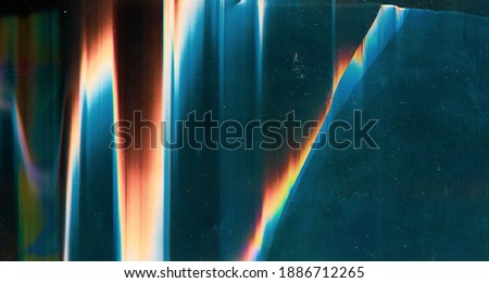 Glitch overlay. Damaged screen. Dust scratches texture. Colorful digital noise design on blue glass shattered display surface with rainbow orange red artifacts stains. Royalty-Free Stock Photo #1886712265