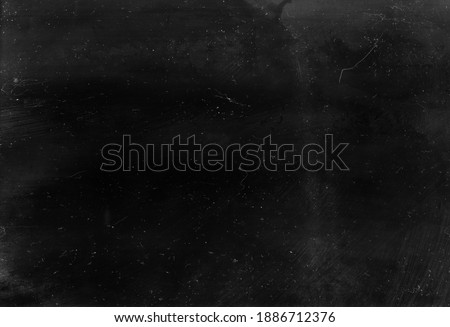 Dust scratched overlay. Weathered chalkboard. Black distressed aged stained surface with gray smeared dirt grainy particles noise effect. Royalty-Free Stock Photo #1886712376
