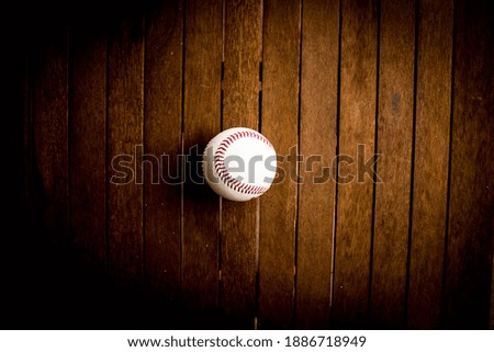 a baseball ball on a wooden background table