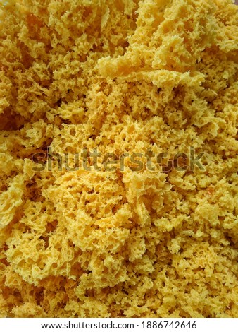 Kremesan is made from chicken or duck stock, corn flour seasoned with garlic, turmeric, coriander, and salt and deep-fried until crisp and golden. Selective focus