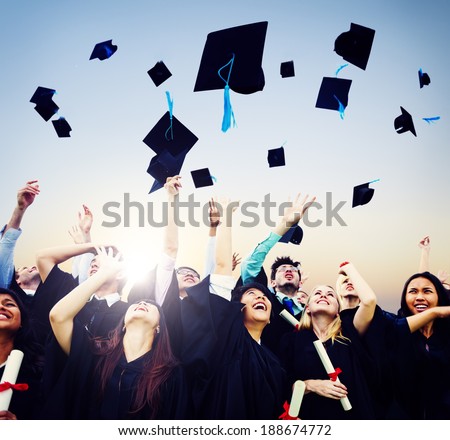 Cheerful students throwing graduation caps in the Air Royalty-Free Stock Photo #188674772