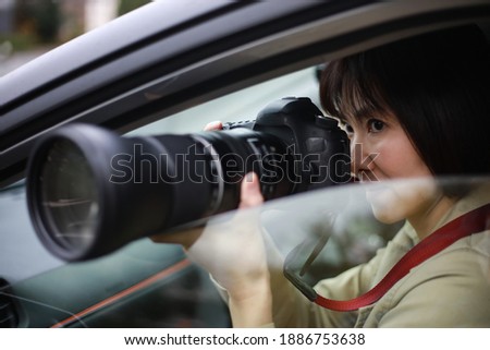 Woman taking pictures from inside the car
