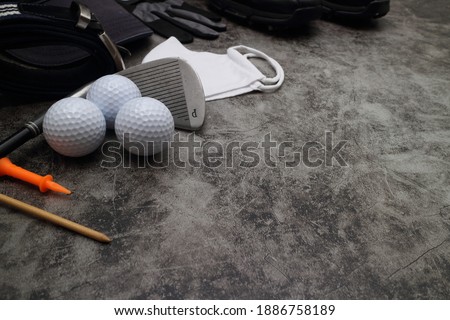 golf ball and accessories on floor 