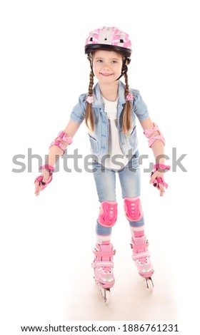 Cute smiling little girl child in pink roller skates and protective gear isolated on a white