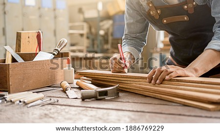 Carpenter working with equipment on wooden table in carpentry shop. woman works in a carpentry shop. Royalty-Free Stock Photo #1886769229