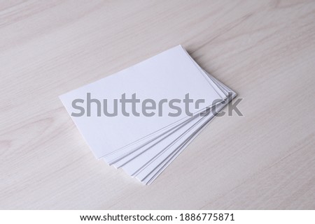 Business card blank on wooden background. Corporate Stationery, Branding Mock-up. Creative designer desk. Flat lay. Copy space for text. Template for ID