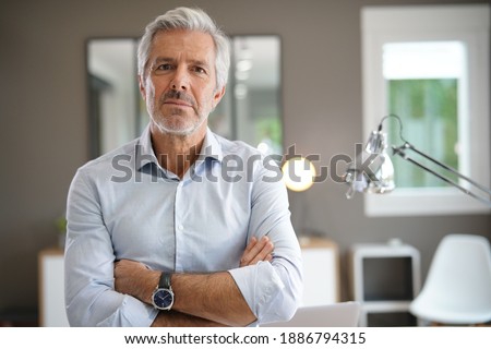 Portrait of senior businessman with arms crossed looking at camera Royalty-Free Stock Photo #1886794315