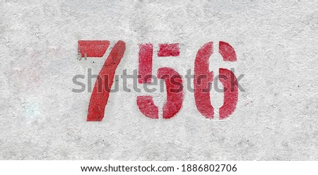 Red Number 756 on the white wall. Spray paint.