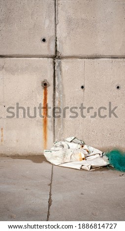 Net and bag on concrete ground in a port