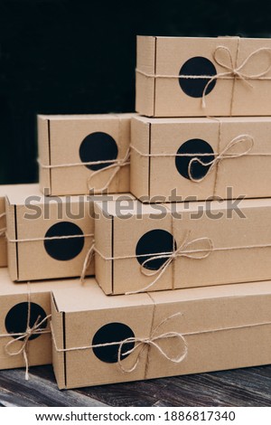 Cardboard boxes with ribbons on a black background.