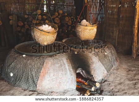 picture of production of natural rock salt by boiling saline from Sinthao salt pond in small village of Nan, Thailand