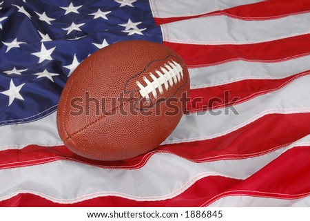 American Football with flag in background