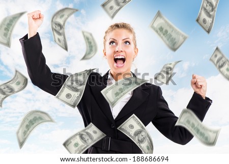 Happy Businesswoman under money rain.